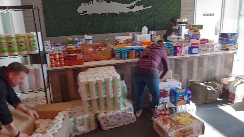 Volunteers unpacking cases of goods