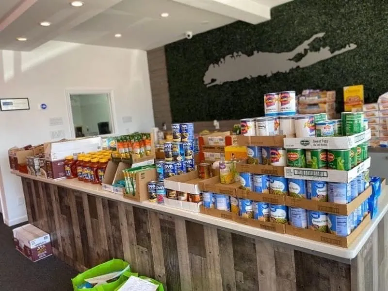 Donated groceries stacked on the counter of the East Neck Insurance office in April 2020